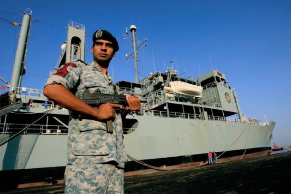 A Takavaran (Iranian navy special forces) stands guard near the Iranian Kharg replenishment ship in Port Sudan on Wednesday. Photo: AFP