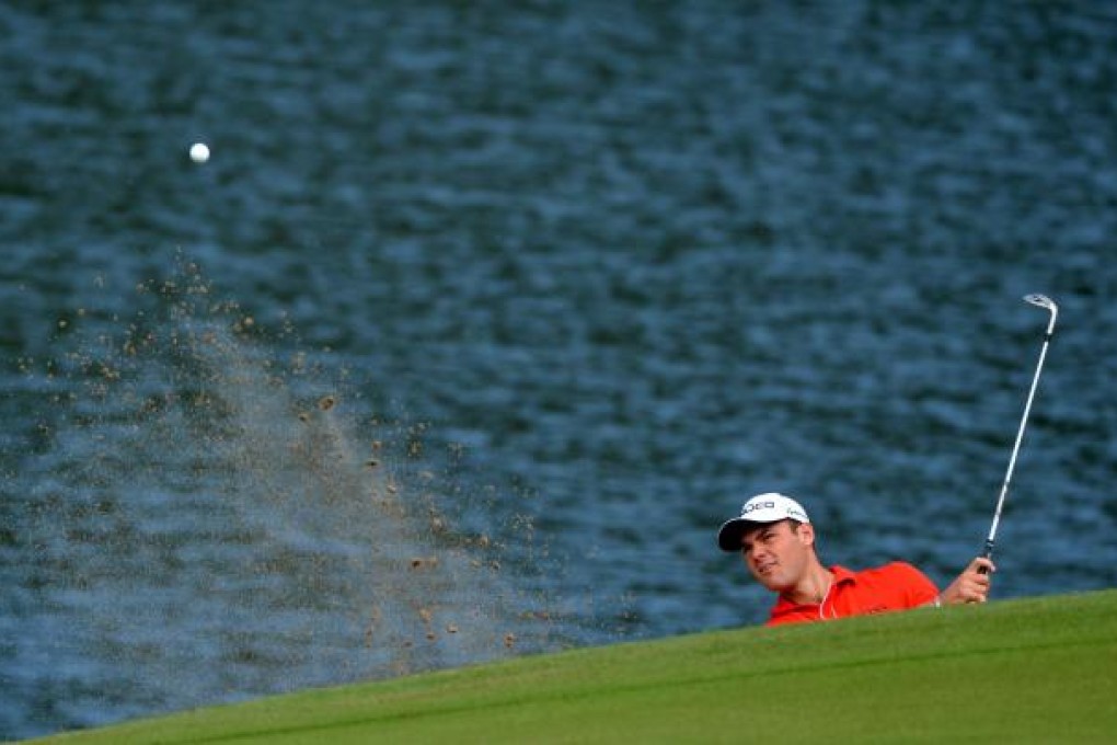 Defending champion Martin Kaymer plays from the bunker at the 15th hole during the first round of the WGC-HSBC Champions. Photo: AFP