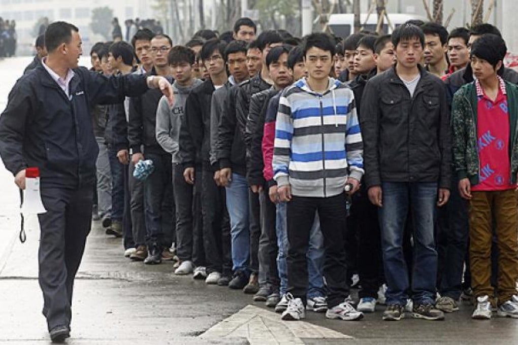 Job seekers outside the Foxconn recruitment centre in Shenzhen. Photo: Reuters