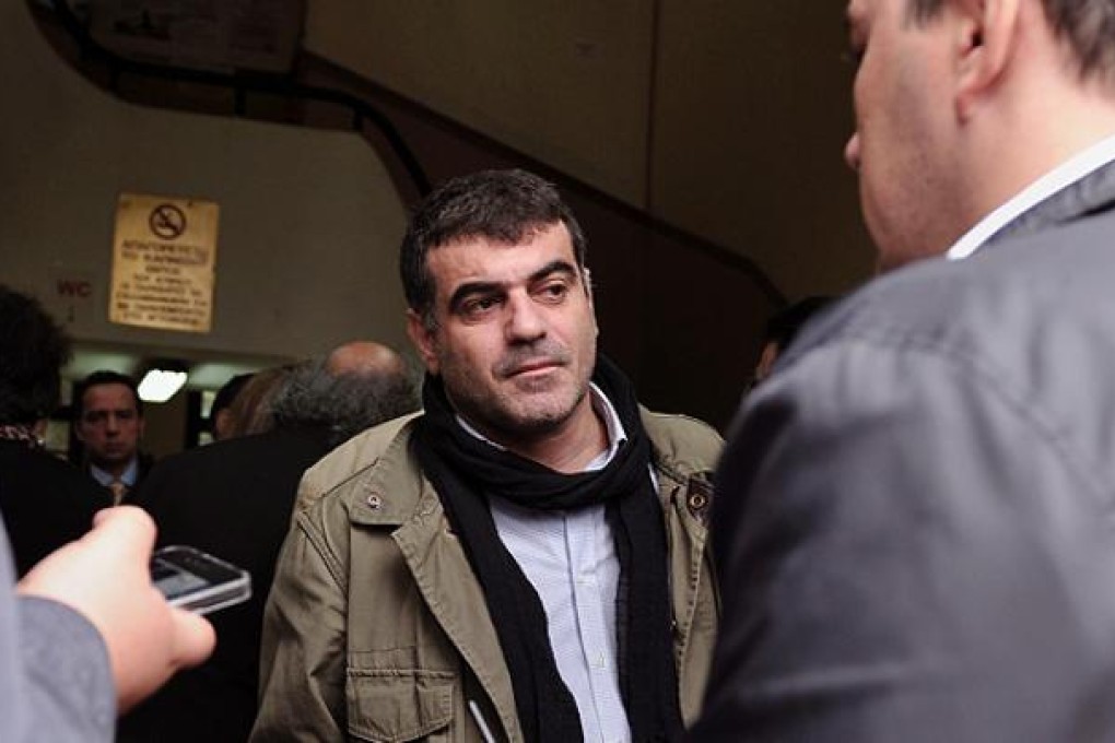 Costas Vaxevanis speaks to journalists at an Athens courthouse. Photo: AFP