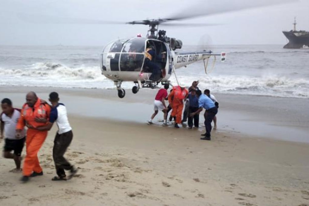 Indian Coast Guards lead crew members of the Indian ship Pratibha Cauvery to safety during a rescue mission on Thursday. Photo: AP