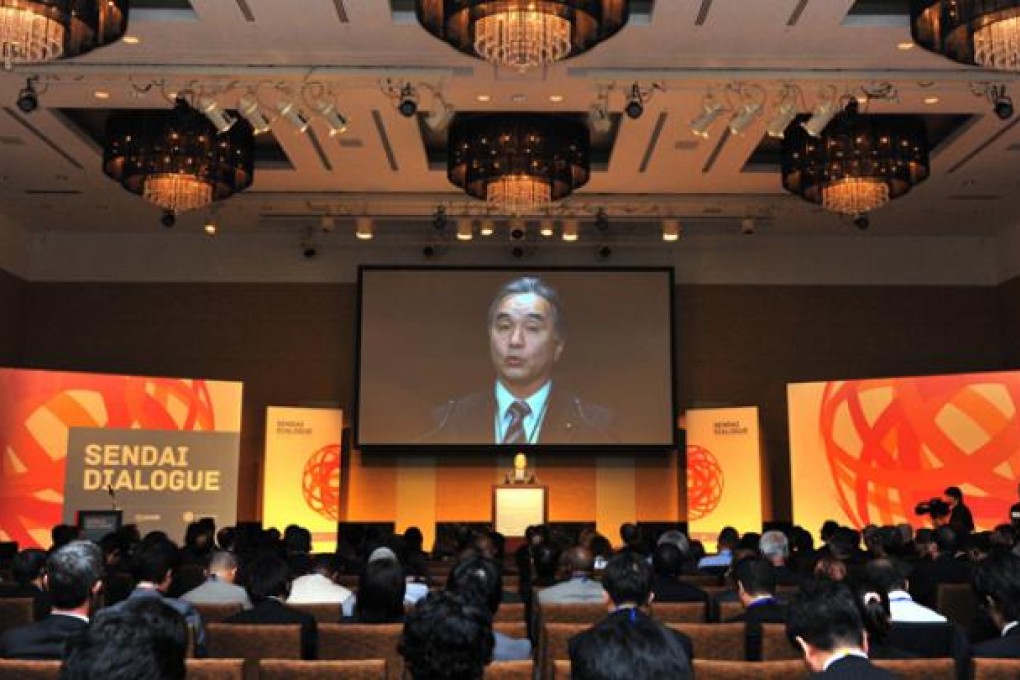 Japan's Reconstruction Minister Tatsuo Hirano delivers a speech at a conference on disaster prevention and development issues on October 9. Photo: AFP