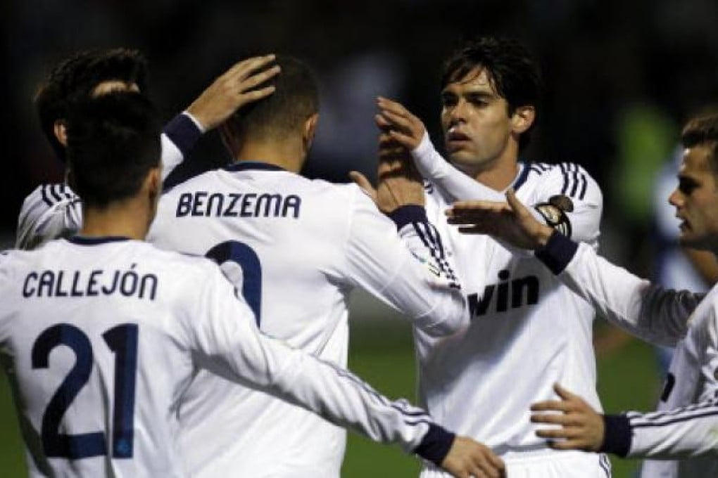 Real Madrid's Karim Benzema from France (centre) is congratulated by teammate Kaka (second right) after scoring against Alcoyano during their Copa del Rey match. Photo: AP