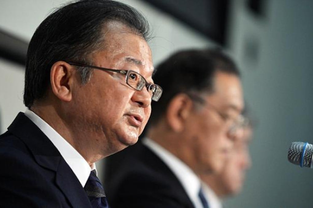 Sharp's president Takashi Okuda announces the company's first half results in Tokyo. Photo: AFP