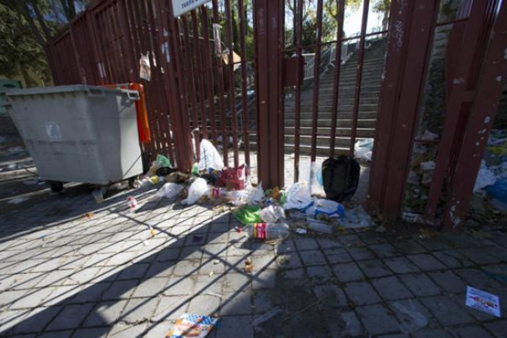 Empty bottles and other debris lie outside the closed gates of the Madrid Arena venue in Madrid on Thursday. Photo: AP