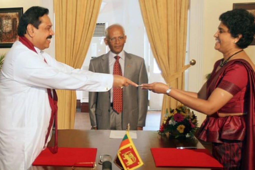 President Mahinda Rajapakse (left) presenting a letter of appointment to Shirani Bandaranayake, Sri Lanka's first woman chief justice. Photo: AFP
