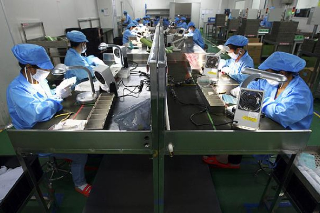 Workers assemble LED products at a factory in Suining, Sichuan province. Photo: AP