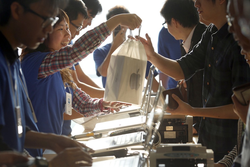 Customers at the Apple store at the IFC in Central Hong Kong purchase the iPad Mini. Photo: AP