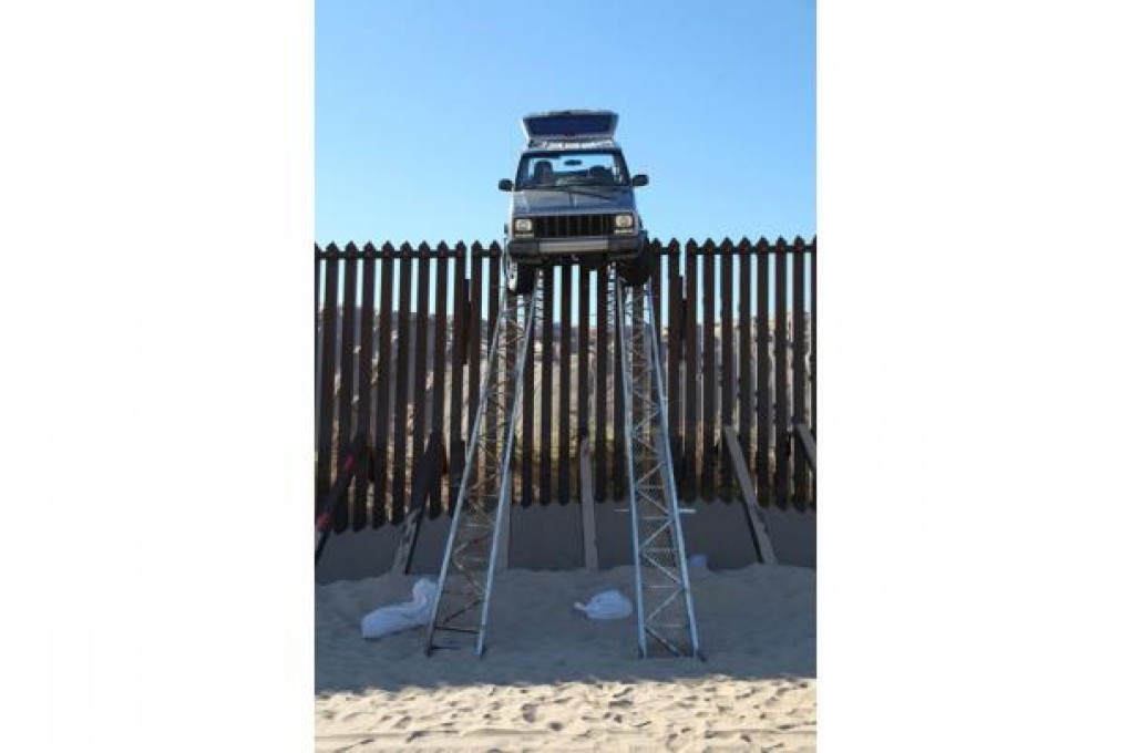 The Jeep stuck at the top of the makeshift ramp. Photo: AP