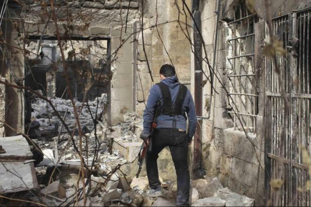 A member of the Free Syrian Army walks in an area of Aleppo where clashes with pro-government forces continue. Photo: Reuters