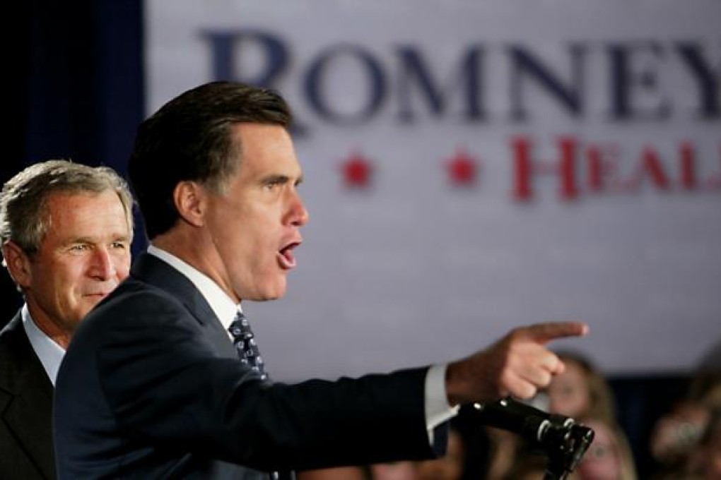 US President George W. Bush (L) stands beside Massachusetts gubernatorial candidate Mitt Romney (R) at the Seaport Hotel 04 October 2002 in Boston, Massachusetts. Photo: AFP
