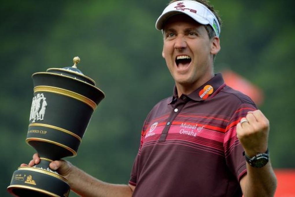 Ian Poulter celebrates with the trophy after winning the WGC-HSBC Champions tournament at Mission Hills in Dongguan. Photo: AFP