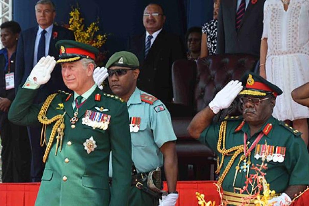 The Prince of Wales salutes the Royal Pacific Islands Regiment at Sir John Guise Stadium in Port Moresby on Sunday. Photo: EPA