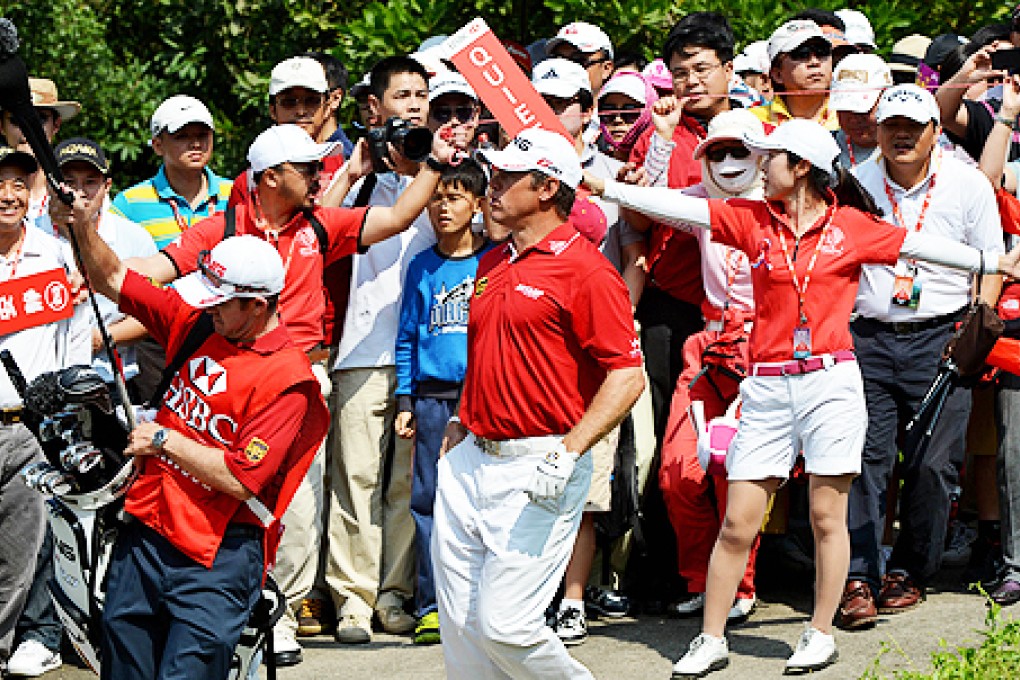 Lee Westwood of England walks towards the green after teeing off. Photo: AFP