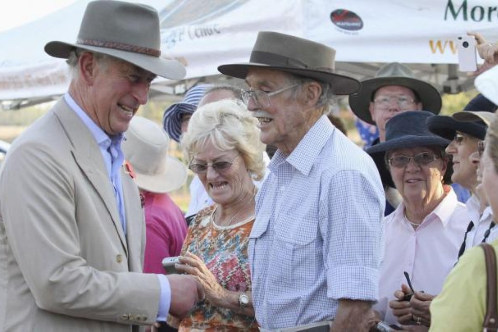 Prince Charles (left) is greeted in Queensland. Photo: Reuters