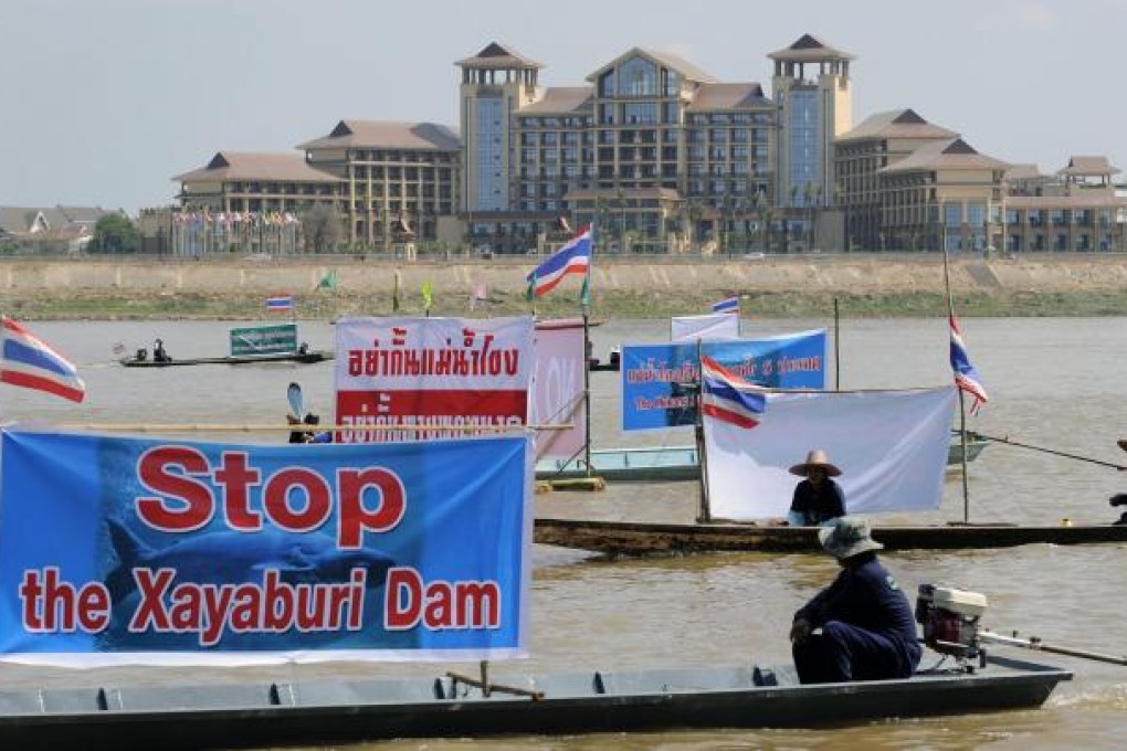 Thai activists and villagers protest opposite Laos. Photo: EPA