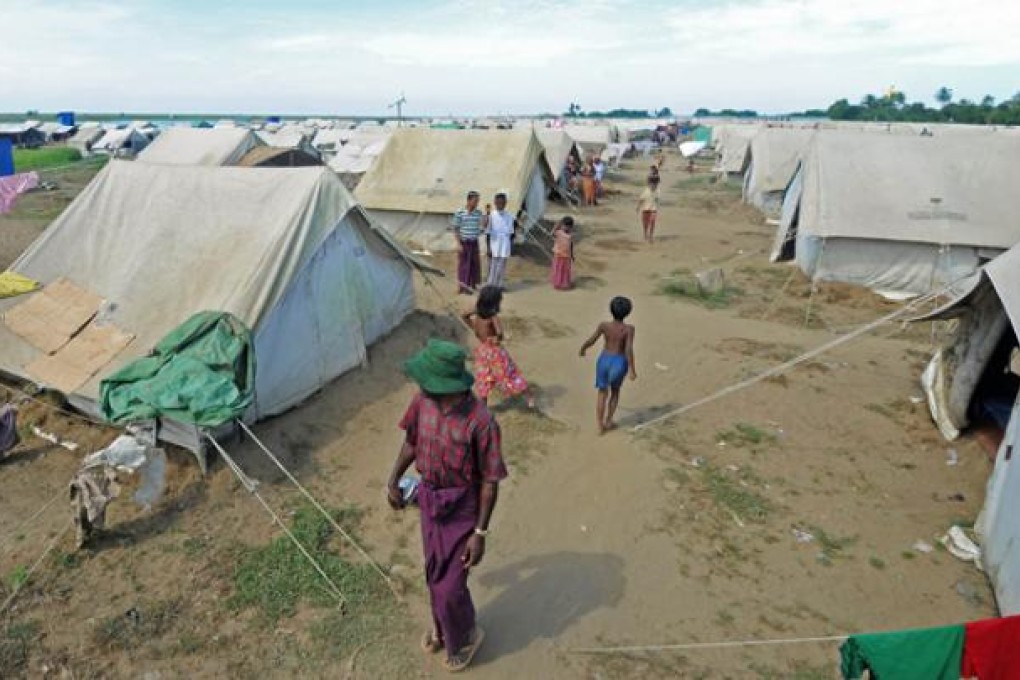 Muslim Rohingya people walk around the Bawdupha Internally Displaced Persons (IDP) camp on the outskirts of Sittwe, western Rakhine state on Friday. Photo: AFP