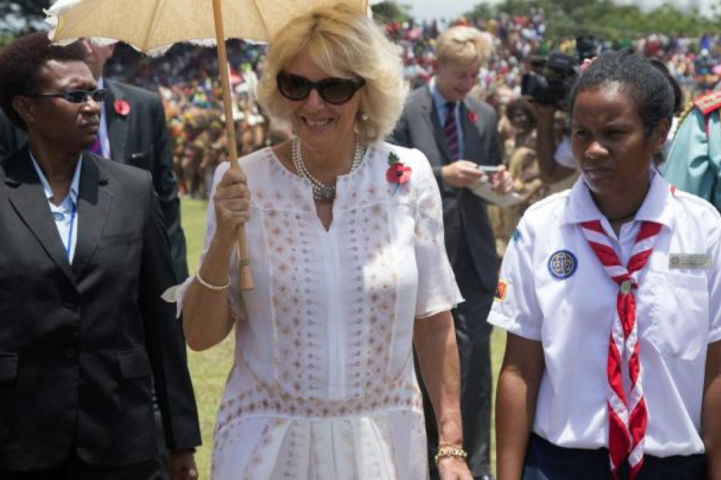 Camilla, Duchess of Cornwall, walks next to a girl scout through Sir John Guise Stadium, Papua New Guinea. Photo: EPA