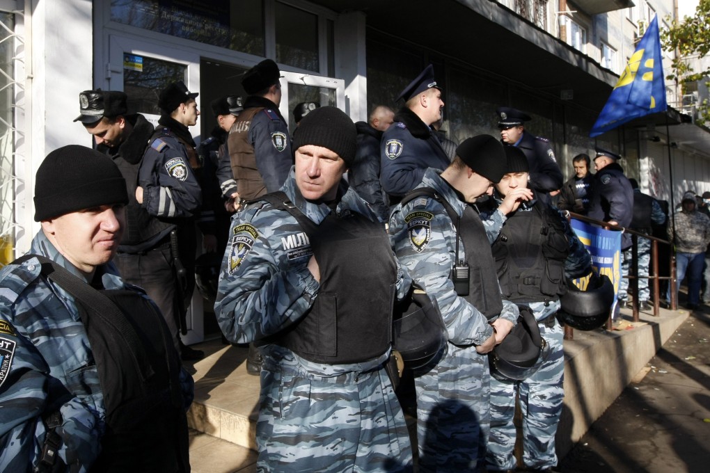 Police officers prepare to meet a protest rally outside an election precinct, where the opposition said election fraud happened, in Kiev. Photo: Reuters
