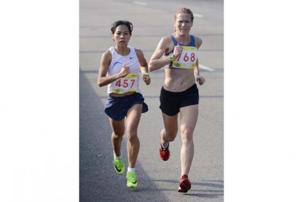 Yiu Kit-ching and Michelle Lowry run side by side in the Asics 10km Challenge. Photo: Richard Castka