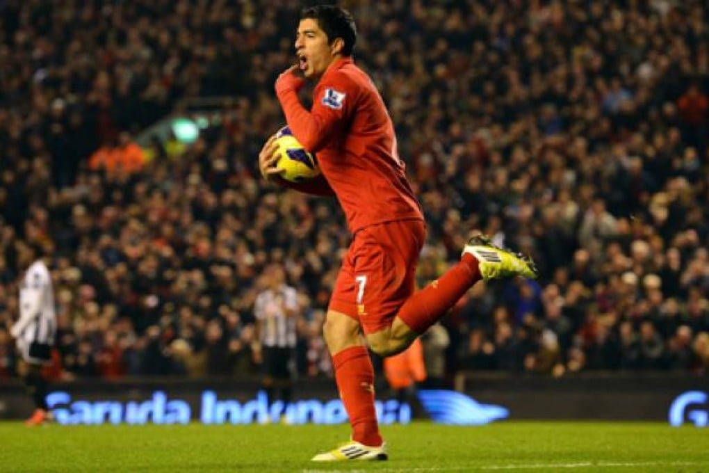 Liverpool's Luis Suarez celebrates after scoring the equaliser against Newcastle United at Anfield on Sunday. Photo:AFP