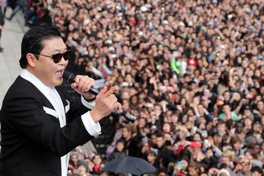 Psy performs his hit song Gangnam Style in front of a flash mob crowd in Paris on Monday. Photo: AFP