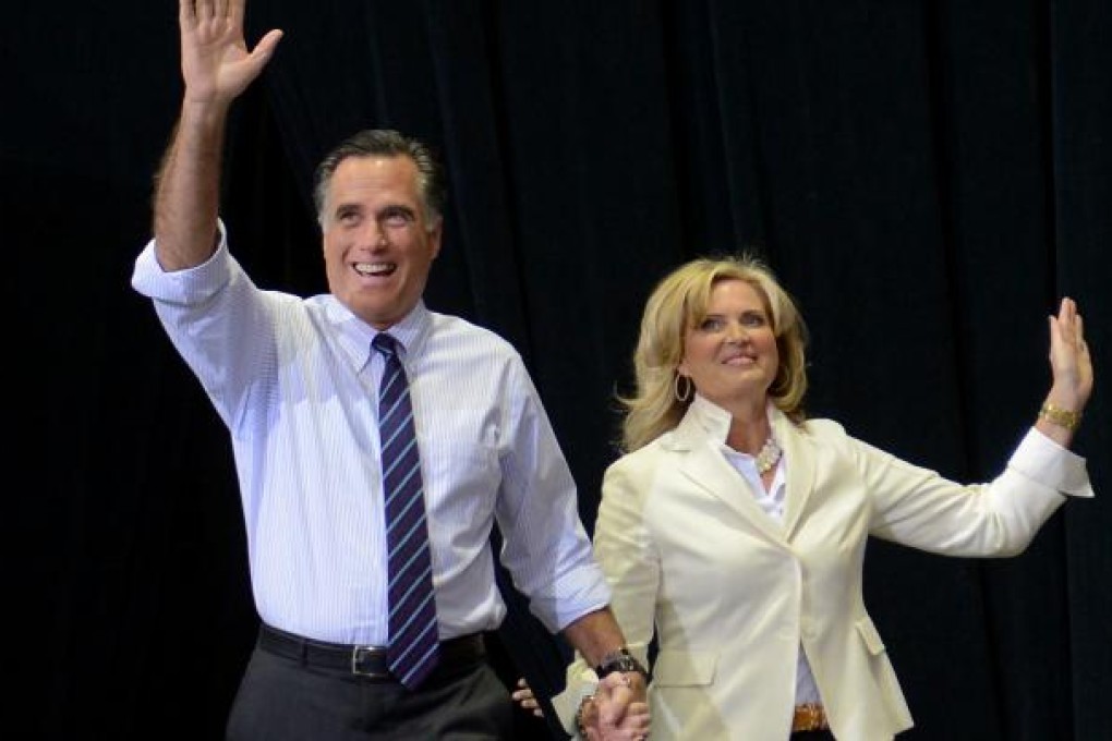 Mitt Romney arrives at a rally with his wife, Ann. Photo: AFP
