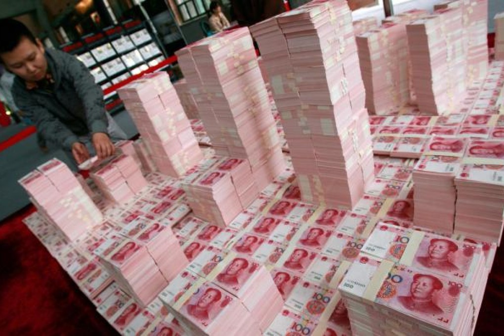 An artist uses 100-yuan notes to build a model. The currency was trading strongly yesterday. Photo: AFP