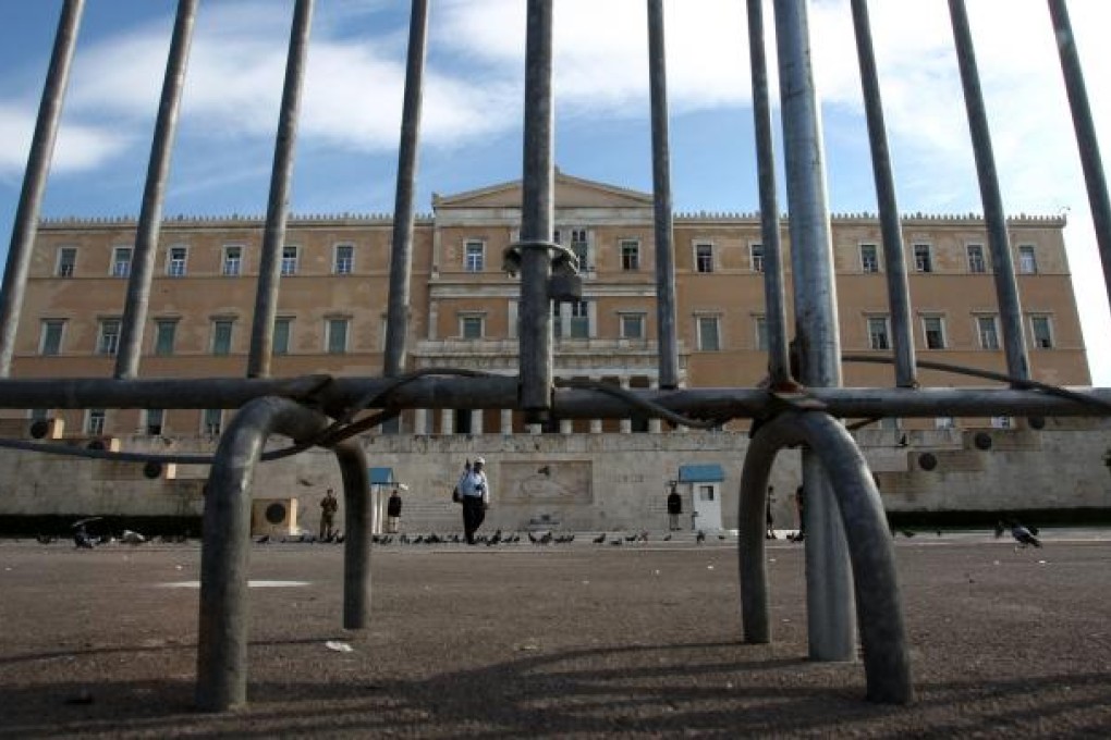 Fences have been placed around the Greek parliament, ahead of the 48-hour nationwide general strike, in central Athens. Photo: AP