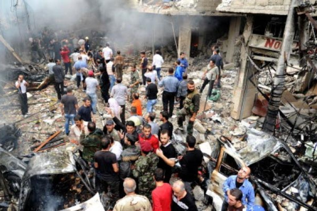 Syrian citizens gathering at the site of bomb explosion at the Mazzeh Jabal area in Damascus. Photo: EPA