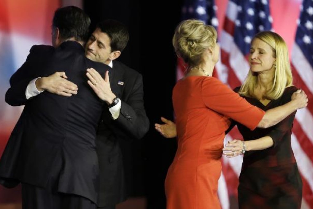 Mitt Romney (above left) embraces running mate Paul Ryan after conceding the race. Photo: AP