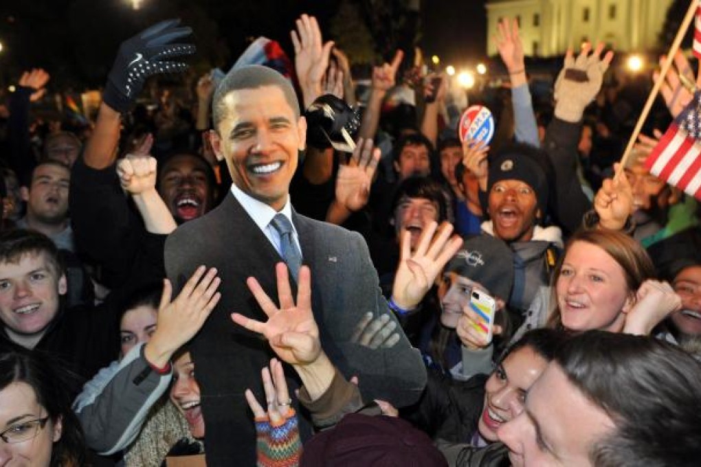 Celebrations outside the White House with a cardboard cutout of Obama. Photo: AFP