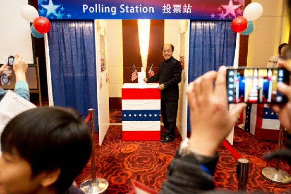 People try out a mock polling station at a hotel during a US presidential election results event organised by the US embassy in Beijing on Wednesday. Photo: AFP
