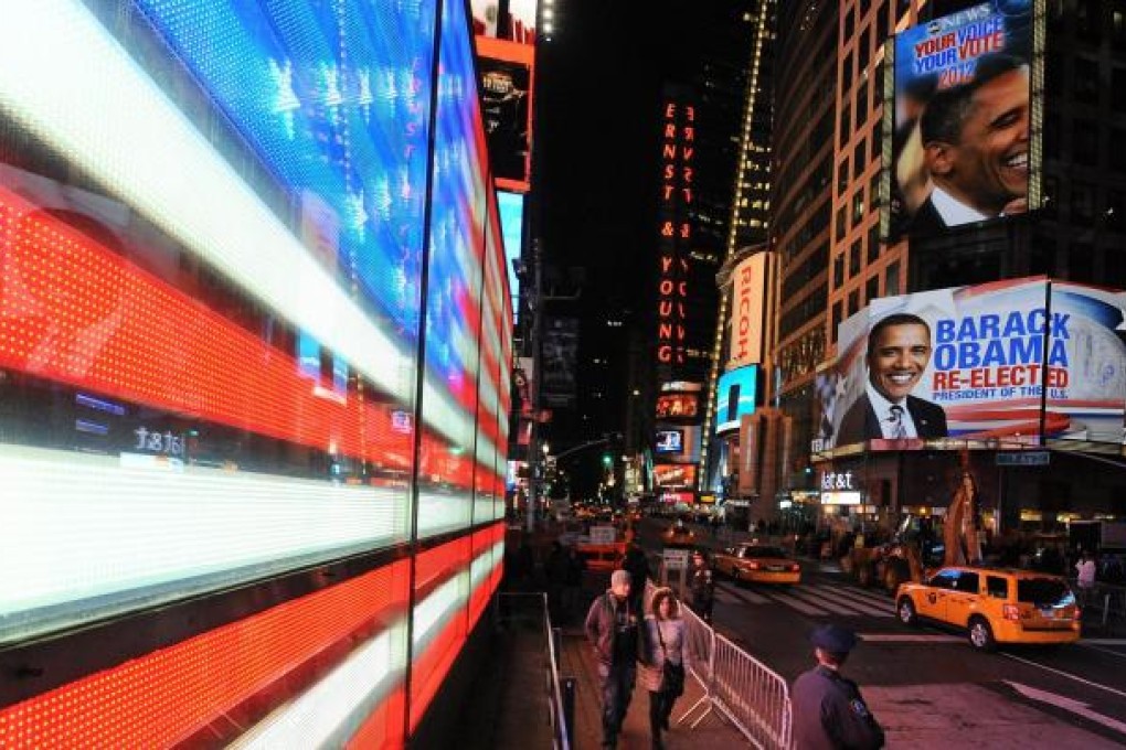 President Barack Obama's re-election is announced in New York's Times Square. The results were forecast with uncanny accuracy by young mathematicians. Photo: EPA