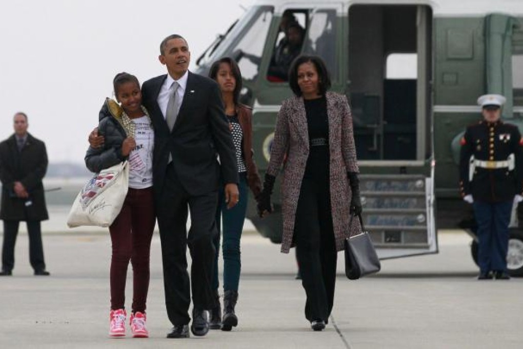 US President Barack Obama, first lady Michelle Obama and their daughters Sasha, left, and Malia return to Washington following Obama's second-term win on Tuesday. Photo: Reuters