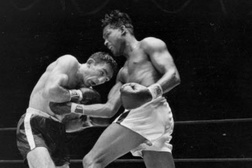 world middleweight champion Sugar Ray Robinson, right, fighting challenger Carmen Basilio (left) in 1957. Basilio has died aged 85. Photo: AP