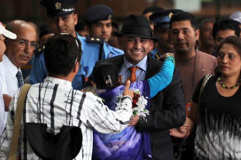 Chandrakala Mainali welcomes home her son. Photo: AFP