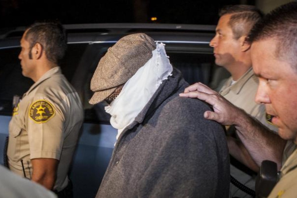 Mark Basseley Youssef is escorted from his home by Los Angeles County Sheriff's officers on September 15. Photo: Reuters