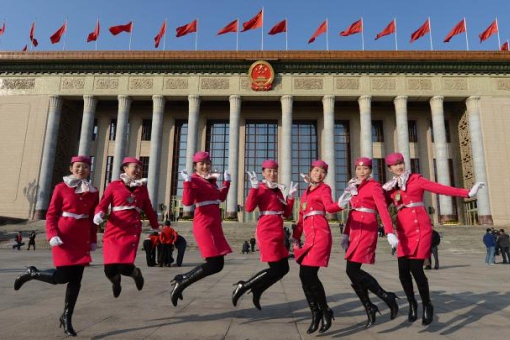 Chinese hostesses jump before the opening session of the Chinese Communist Party's five-yearly congress. Photo: AFP
