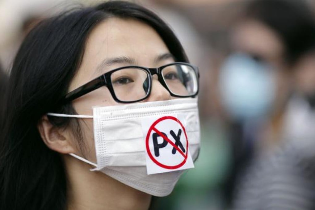 A protester wears a mask with a reference to the dangerous chemical paraxylene that the Ningbo plant already produces. Photo: Reuters