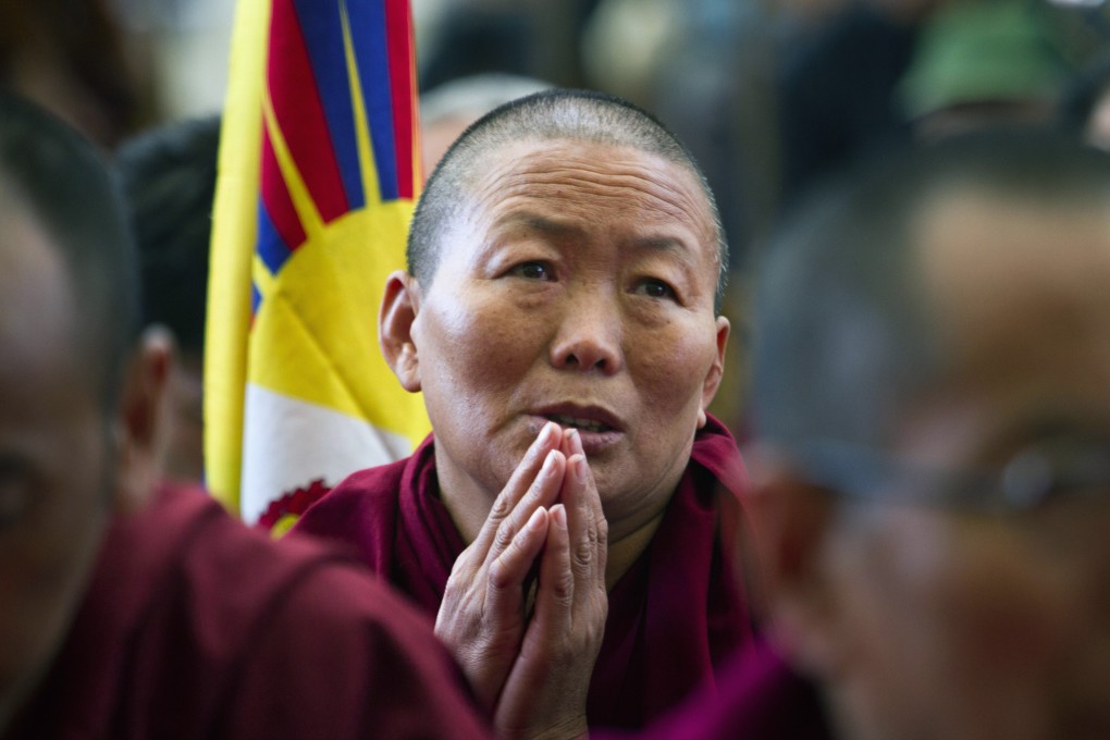 An exiled Tibetan Buddhist nun in Dharamsala,India, prays in solidarity with Tibetans who have self-immolated in China. Photo: AP