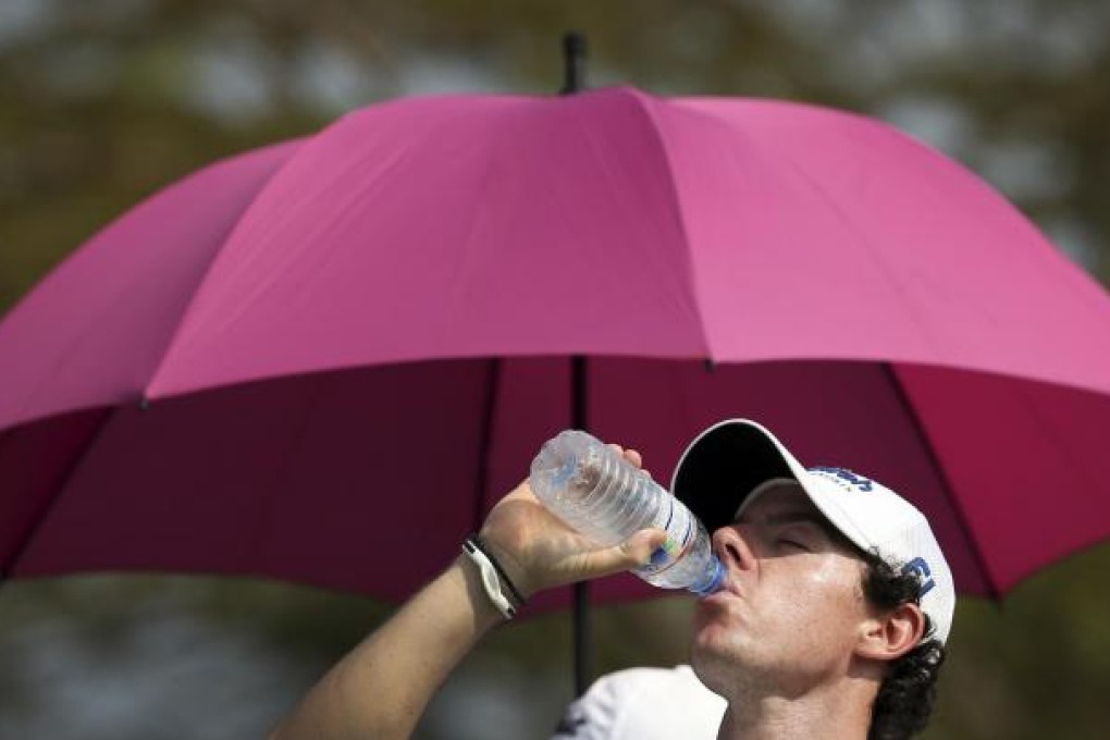 Rory McIlroy takes a drink break before the storms hit. Photo: AP