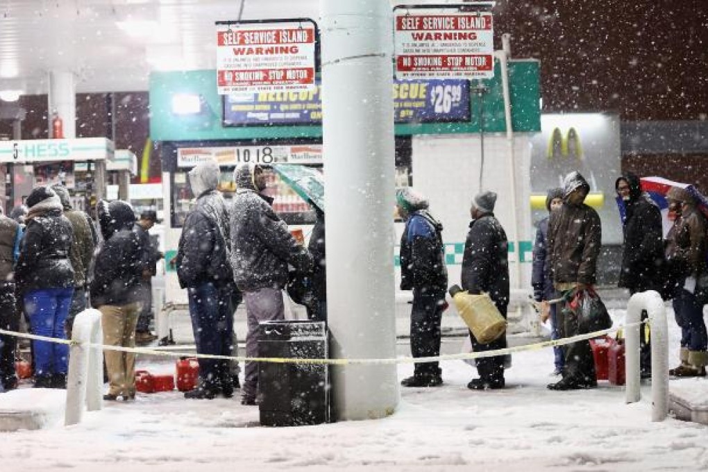 People queue up for petrol in snowy Brooklyn. Photo: AFP