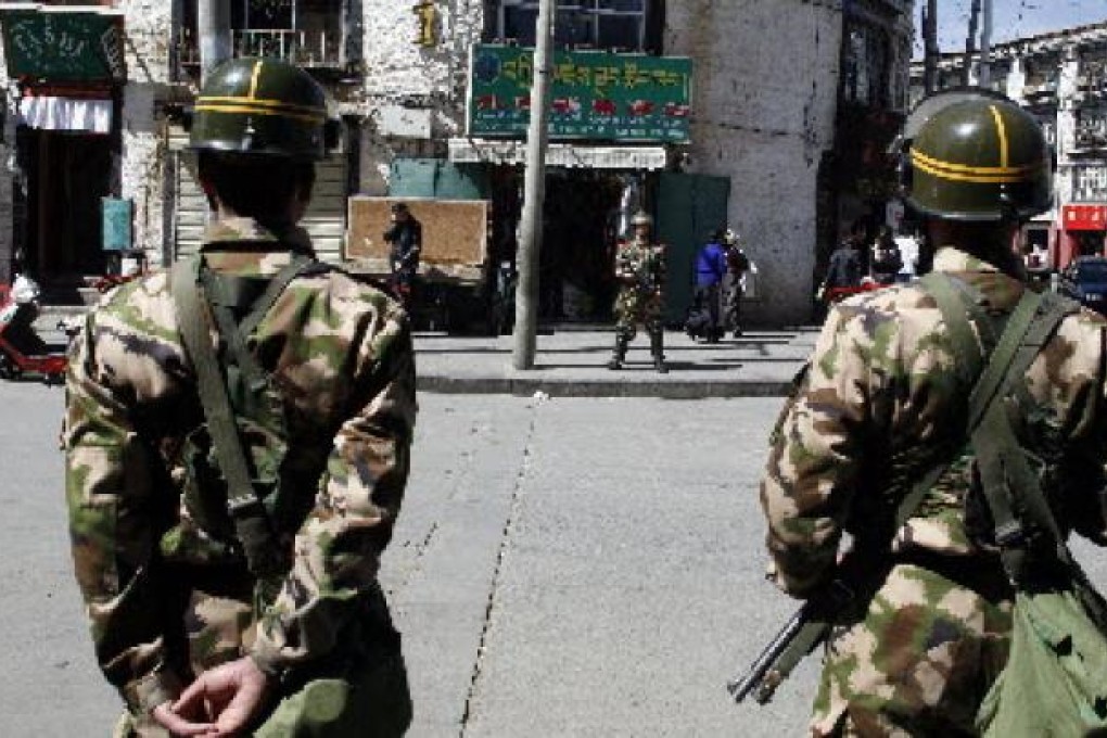 Chinese military personnel on a street of Lhasa in Tibet. China is boosting security in Tibet. Photo: AP