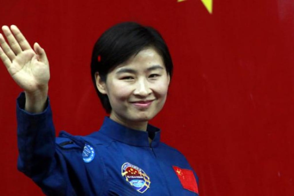 Liu Yang, China's first woman astronaut, waves as she leaves the Jiuquan satellite launch centre in western China's Gansu province. Photo: AP