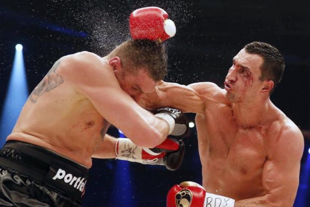 Champion Vladimir Klitschko lands a blow to the head of Polish challenger Mariusz Wach on his way to a points victory. Photo: Reuters