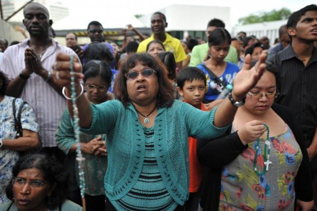 Catholics gather outside a hospital near Kuala Lumpur, where, they say, an image of the Virgin Mary has appeared. Photos: AFP