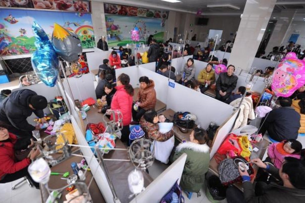 Parents tend their babies in a crowded hospital. About 16 million babies are born on the mainland every year. Photo: Imaginechina