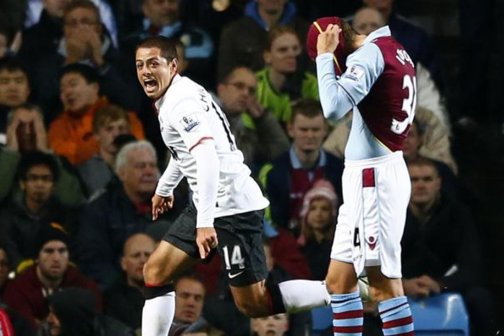 Manchester United's Javier Hernandez celebrates his second goal as Aston Villa's Matthew Lowton hides his head. Photo: Reuters