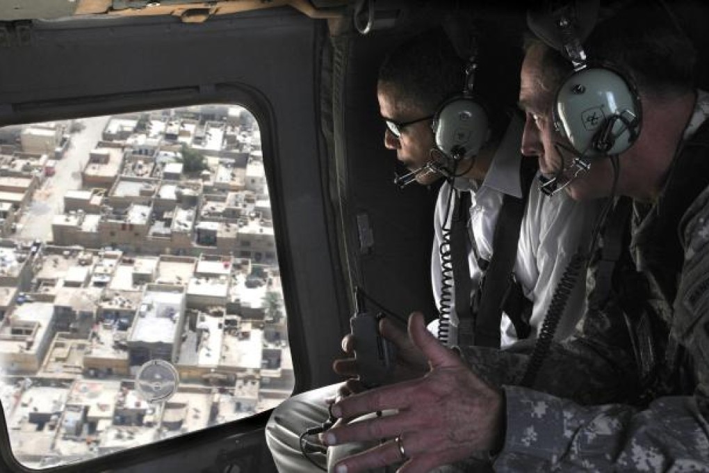 Then presidential candidate Barack Obama (left) takes a helicopter ride over Baghdad with David Petraeus in July, 2008. Photo: AP